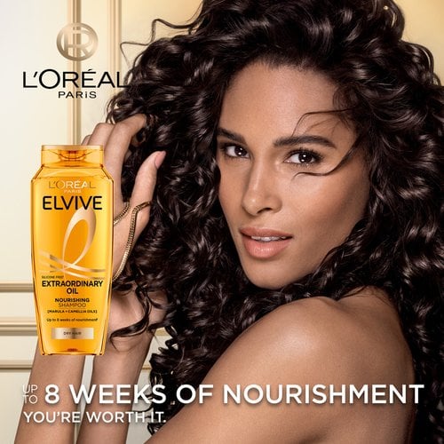 Extraordinary Oils Hero Image Model with long brown hair