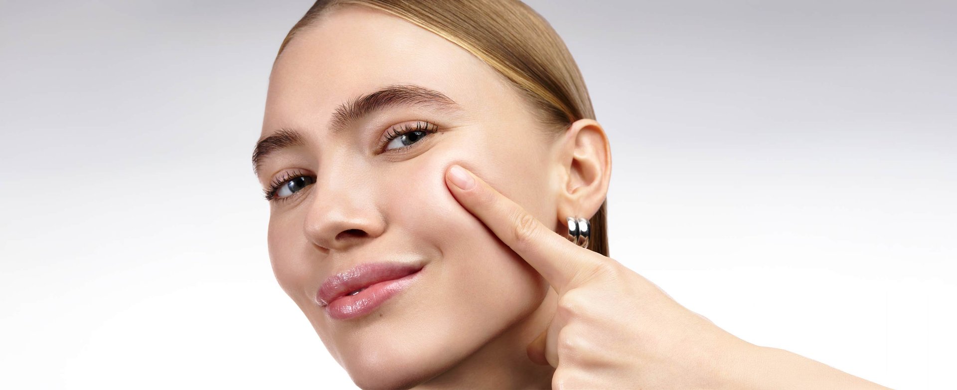 Close-up of a woman showcasing replumped, glowing, and strengthened mature skin after following an anti-ageing routine.