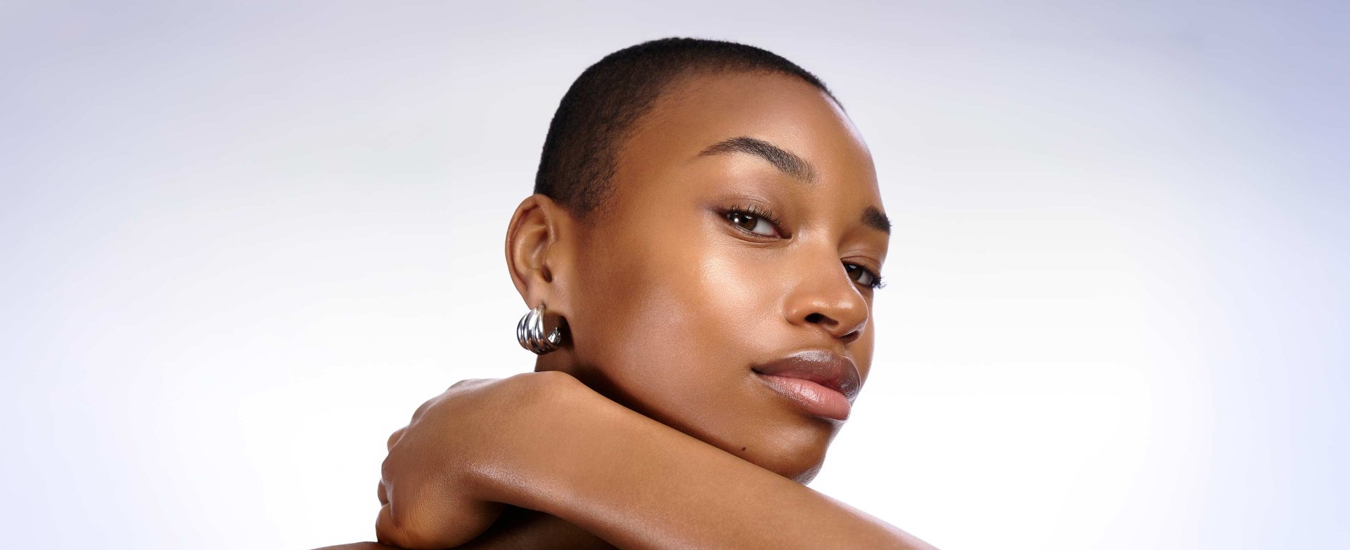 Close-up portrait of a woman showcasing healthy, glowing, and deeply hydrated skin after using hyaluronic acid.