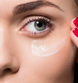 woman applying glycolic acid cream