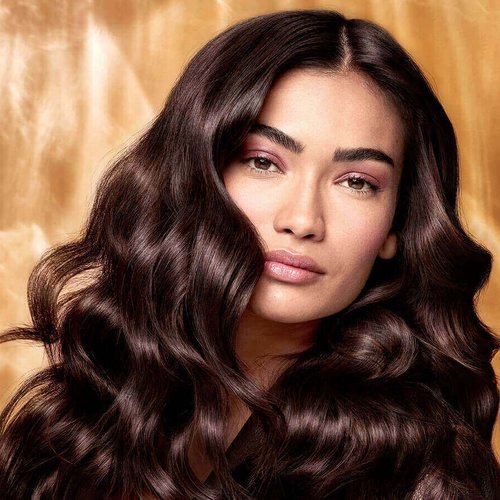 Extraordinary Oils Hero Image Model with long brown hair