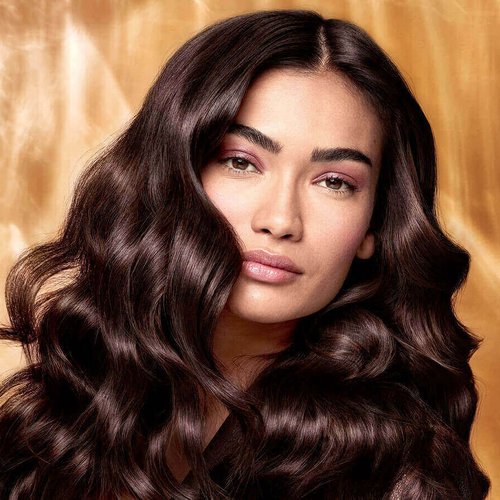 Extraordinary Oils Hero Image Model with long brown hair