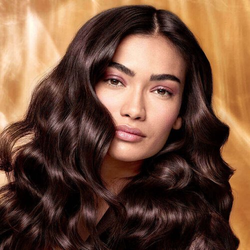 Extraordinary Oils Hero Image Model with long brown hair