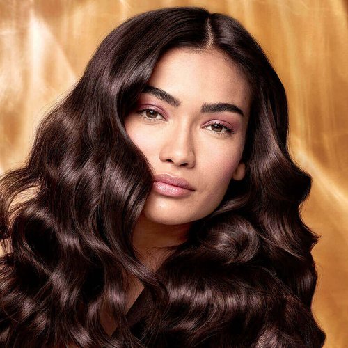 Extraordinary Oils Hero Image Model with long brown hair