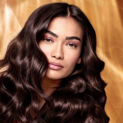 Extraordinary Oils Hero Image Model with long brown hair